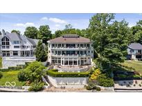 Impressive multi-level home with lake views and manicured landscaping at 10919 Brigantine Dr, Indianapolis, IN 46256