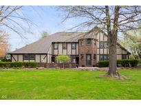 Charming Tudor-style home with a well-manicured lawn and mature landscaping at 1122 Mill Run Dr, Noblesville, IN 46062