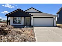 New construction home with white siding, black trim, and a two-car garage, set against a blue sky at 1319 Fleming Dr, Greenfield, IN 46140