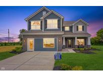 Charming two-story home boasts a brick-accented facade, blue siding, and an inviting covered entry at 187 Luna Pl, Shelbyville, IN 46176