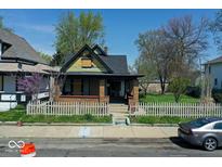 Charming home featuring a cozy front porch and classic architectural details at 3320 E New York St, Indianapolis, IN 46201
