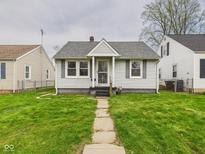 Charming bungalow featuring a well-manicured lawn and a welcoming walkway at 3826 Delaware St, Anderson, IN 46013
