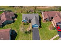 An aerial view of a well-maintained home with a lush lawn and easy access to the adjacent river at 5708 Crystal Bay W Dr, Plainfield, IN 46168
