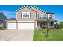 Charming two-story home with three-car garage and well-maintained lawn in a suburban neighborhood at 5886 N Peppereel Way, McCordsville, IN 46055