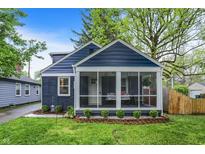 Charming home with a screened porch, blue siding, and well-maintained landscaping at 6106 Evanston Ave, Indianapolis, IN 46220