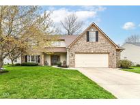 Charming two-story home featuring a brick facade, well-maintained lawn, and attached two-car garage at 693 Prince Dr, Greenwood, IN 46142