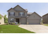 Charming two-story home with a three-car garage and manicured lawn at 7215 Barrett Dr, Brownsburg, IN 46112