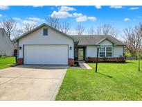 Charming single-story home featuring an attached garage, well-maintained lawn, and appealing curb appeal at 8110 Madrone Ct, Indianapolis, IN 46236