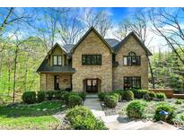 Charming brick home with manicured landscaping, mature trees and beautiful architectural details at 8191 S Bayview Ct, Trafalgar, IN 46181