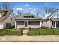 Charming single-story home with a cozy screened-in porch and well-maintained front yard at 1114 N Mount St, Indianapolis, IN 46222