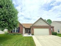 Charming single-story home with brick and siding exterior, well-manicured lawn, and two car garage at 1649 Woodfield Dr, Greenwood, IN 46143