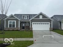 Charming single-story home featuring a two-car garage, gray siding, manicured lawn and stylish architectural details at 19774 Highclere Ln, Sheridan, IN 46069