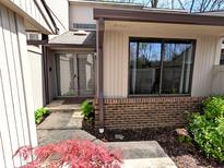 Charming front entrance with a brick accent and a storm door at 21 Osage Ct, Columbus, IN 47201