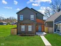 Charming two-story home with gray siding, wood accents, and a well-manicured lawn at 2325 E Brookside Ave, Indianapolis, IN 46218
