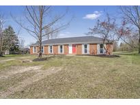 Charming single-story brick home with a red front door and well-manicured landscaping at 2526 David Dr, Westfield, IN 46074
