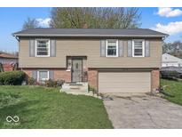 Charming two-story home featuring neutral siding, grey shutters and a two-car garage at 3432 Joan Pl, Indianapolis, IN 46226