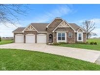 Charming brick home featuring a three-car garage, well-manicured lawn, and inviting curb appeal at 52 E 286Th St, Atlanta, IN 46031