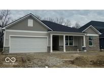 Charming single-story home with a two-car garage and covered front porch at 6474 Ambassador Dr, Plainfield, IN 46168