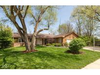 Charming single-story home with a well-manicured lawn and mature tree at 1186 Castle Dr, Franklin, IN 46131