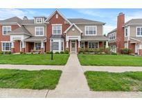 Charming two-story home with a well-manicured lawn and inviting walkway at 1352 Middlebury Dr, Westfield, IN 46074