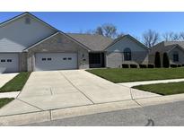 Charming single-story home with attached garage, well-maintained lawn, and long concrete driveway at 160 Bay Ridge Dr, Pendleton, IN 46064