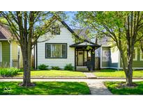 Charming two-story home with a well-maintained lawn and inviting front porch at 1917 Fletcher Ave, Indianapolis, IN 46203