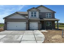 New construction two-story home with brick accents and a three car garage at 196 Aster Way, Greenfield, IN 46140