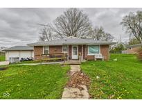Quaint brick home with a ramp leading to the front door and a spacious yard with dandelions at 306 W Clyde St, Frankton, IN 46044