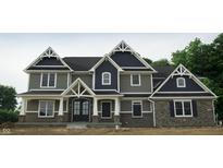 Beautiful two-story home with striking architectural details and a combination of stone and siding at 5179 Oak Ridge Trl, Columbus, IN 47201