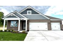 Charming new construction home with brick and gray siding and a three car garage at 5924 Trichel Dr, Greenwood, IN 46143