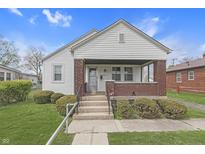 Charming home featuring a gabled roof, brick accents, and a covered front porch at 620 S Irvington Ave, Indianapolis, IN 46219