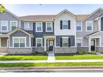 Charming townhome with stylish two-tone exterior, landscaped lawn, and inviting entrance at 7239 Governors Row, Avon, IN 46123