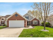 Charming brick home with a manicured lawn and two-car garage, creating excellent curb appeal at 10820 Washington Bay Dr, Fishers, IN 46037