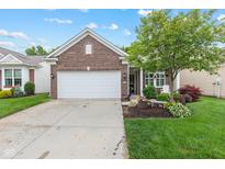 Charming brick home with a well-manicured lawn and a two-car garage in a desirable neighborhood at 12821 Gloria Dr, Fishers, IN 46037