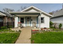 Charming single-Gathering home with a cozy front porch, landscaped with flowers, and a well-maintained lawn at 1510 Asbury St, Indianapolis, IN 46203