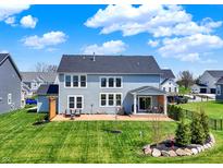 Spacious backyard featuring a well-maintained lawn and a cozy patio area at 16683 Alex Dr, Noblesville, IN 46060