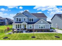 Charming two-story home featuring a covered front porch and well-manicured lawn at 16683 Alex Dr, Noblesville, IN 46060