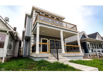 Charming two-story home with a covered porch and upper level balcony at 1723 Fletcher Ave, Indianapolis, IN 46203