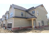 Two-story home with a two-car garage, red brick foundation, and covered porch at 17466 Ebling Trl, Westfield, IN 46062