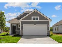 Charming single-Gathering home showcases a gray exterior, stone accents, and a spacious two-car garage at 2276 Marjorie Way, Shelbyville, IN 46176
