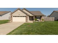 Charming single-Gathering home featuring a well-manicured lawn and an attached two-car garage at 2923 Armaugh Dr, Brownsburg, IN 46112