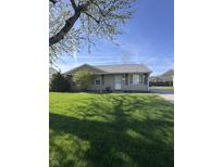 Charming single-story home with a well-maintained lawn and beautiful landscaping at 369 Northfield Dr, Mooresville, IN 46158