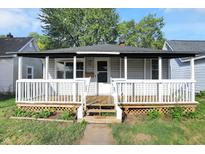 Charming home with a cozy front porch, manicured lawn, and mature trees, creating a welcoming curb appeal at 42 N Gladstone Ave, Columbus, IN 47201