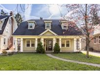 Charming home featuring lovely landscaping and inviting front porch area at 4247 Central Ave, Indianapolis, IN 46205