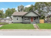 Charming single-Gathering home featuring a cozy front porch and a well-manicured lawn at 5074 E Walnut St, Indianapolis, IN 46201
