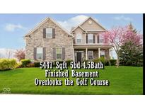 Charming two-story home with a stone facade, manicured lawn, and a beautiful flowering tree at 5196 E County Road 100 S, Avon, IN 46123