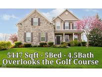Charming two-story home with a stone facade, manicured lawn, and mature landscaping at 5196 E County Road 100 S, Avon, IN 46123