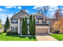 Charming two-story home with a well-manicured lawn and a two-car garage at 5549 Dill Ct, Indianapolis, IN 46237