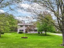 Charming two-story home with a lush green lawn and mature trees at 6113 N 250 E, Greenfield, IN 46140