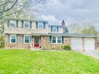 Charming two-story home with brick and siding exterior and well-manicured lawn at 8231 Trevellian Way, Indianapolis, IN 46217